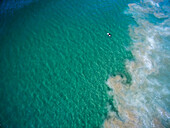 Aerial view of a surfer off Zuma Beach.