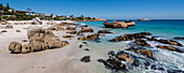 Felsiges Ufer mit großen Felsbrocken und Strandhäusern am Atlantischen Ozean am Clifton Beach; Kapstadt, Westkap, Südafrika