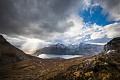 Sun breaking through heavy cloud near Kinlochewe, Torridon; Scotland, United Kingdom