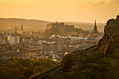 Looking across from Arthur's Seat to Edinburgh Castle and city at dusk; Edinburgh, Scotland, United Kingdom