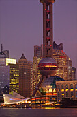 The Pudong district with the Oriental Pearl TV Tower seen from the Bund, Shanghai, China at dusk.; Pudong district, Shanghai, China.