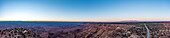 Vast barren landscape at sunset with a road stretching to the distant horizon in Canyonlands National Park, Utah, USA; Utah, United States of America