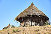 Close-up view of African round huts against the blue sky, traditional dwelling in the rural countryside; Ethiopia