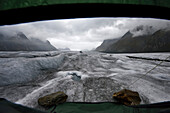 The view from inside a tent over the Aletsch Glacier after a storm.; Aletsch Glacier, Fiesch, Switzerland.