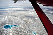 A large pool of water remains on the surface of an ice cap.; Greenland.