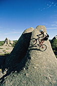 A mountain biker on a rock formation in the Sierra Madres.; Greel, Mexico.