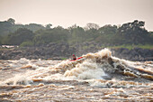 A kayaker paddles through the Kinsuka Rapids on the lower Congo River.; Congo River near Kinshasa, Democratic Republic of Congo.