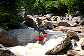 A kayaker on a steep creek ready to boof into Class 5 white water.; Blackwater River, Blackwater State Park, Davis, West Virginia.