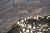 Abandoned village with traditional conical roofed shelters on the mountainside in Ingushetia; Republic of Ingushetia, Russia