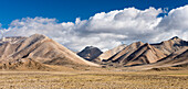 View of the Tibetan plateau with mountain peaks in the background; Tibetan Autonomous Region, Tibet
