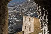 View through rock walls of The Guge Kingdom Ruins in the mountainous landscape of the Sutlej Valley in the Himalayan Mountains; Tsaparang, Zanda, Tibetan Autonomous Region, Tibet