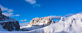 Snow covered mountain peaks of the Saslong and Sella Group in the Dolomites, in the Val Gardena, Bolzano District with a bright blue sky; Trentino Alto Adige, Dolomites, Italy