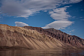 Scenic view of the silt covered mountains lining Greenland's Kaiser Franz Joseph Fjord; East Greenland, Greenland