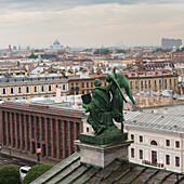 Statue auf einem Dach mit der St. Isaakskathedrale und dem St. Isaakplatz in der Ferne; St. Petersburg Russland