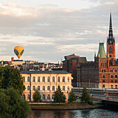 A Hot Air Balloon Floating Above The Buildings; Stockholm Sweden