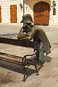 Bronze Statue Of A Soldier Leaning On A Bench In Front Of The French Embassy; Bratislava Slovakia