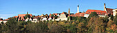 Trees And Buildings Against A Blue Sky; Rothenburg Ob Der Tauber Bavaria Germany