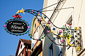 A Decorative Colourful Sign Hanging From A Building; Rothenburg Ob Der Tauber Bavaria Germany