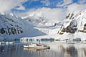 A Ship Sailing Along The Coastline; Antarctica