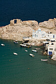 Greece, Cyclades, Island of Milos, Village of Firopotamos, Boats and Buildings near shore.