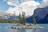 Trees Growing On A Small Rock Island In A Mountain Lake; Banff Alberta Canada