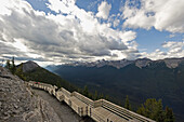 People On A Wooden Boardwalk Along A Ridge Of The Canadian Rocky Mountains; Alberta Canada