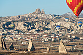Hot Air Balloons In Flight Above The City; Goreme Nevsehir Turkey