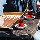 A Man Sits At A Table With Two Beverages And The Game Of Backgammon; Avanos Nevsehir Turkey