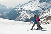 A Couple Skiing In The French Alps; Chaminox-Mont-Blanc Rhone-Alpes France