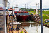 Cargo ship transitioning between Gatun Locks; Panama Canal, Panama