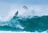 Surfer diving into water off his surfboard; Tarifa, Costa de la Luz, Cadiz, Andalusia, Spain