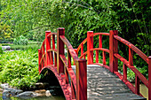 Bridge with red railing crossing stream; Birmingham, Alabama, USA