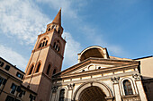 Brick bell tower with stone facade against sky; Ferrara, Emilia-Romagna, Italy
