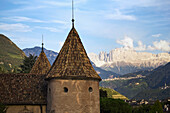Italy, Alto Adige, Bolzano, Castle turret with mountain range in background