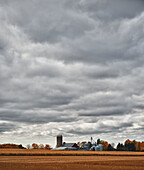 Canada, near London; Ontario, Farmland and farm structures under cloudy sky