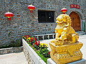 Thailand, Golden lion statue outside building; Shandicun