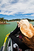 A Girl Holds Her Cowboy Hat On A Boat Cruise From Russell To Paihia; New Zealand