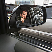 A Man With His Camera Reflected In A Car's Side View Mirror; Seattle, Washington, United States Of America