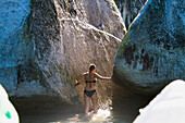 A Girl Wades In The Water At Split Apple Rock In The Abel Tasman National Park; New Zealand