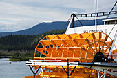 Riverboat With Large Yellow Wheel On The Yukon River; Whitehorse, Yukon, Canada