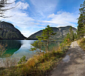 Landscape of a trail beside a clear lake in autumn, Plansee, Tirol, Austria