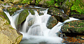 Close-up detail of a river flowing over rocks in autumn, Bavarian Forest Natioanl Park, Bavaria, Germany