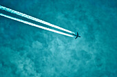 Flugzeug am Himmel mit Kondensstreifen