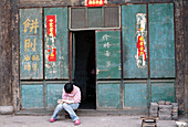 Person Reading Book Outdoors, Pingyao, China