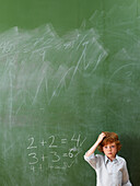 Boy Standing at Blackboard