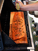 Man Preparing Fish on Grill