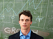 Businessman in Front of Line Graph