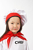 Kleines Mädchen als Koch verkleidet