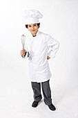 Boy Dressed Up as a Chef Holding a Whisk