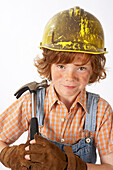 Little Boy Dressed Up as Construction Worker Holding a Hammer